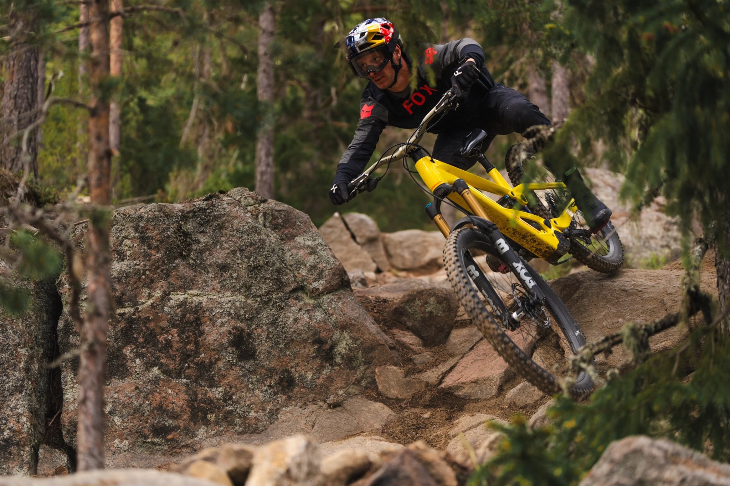 a mountain biker riding the Orbea Wild EMTB over a technical rocky feature